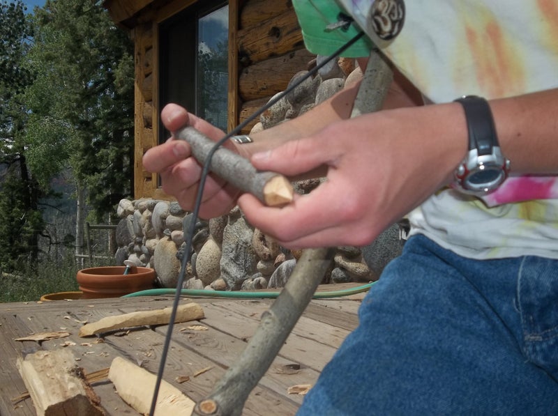Bow drill fire making in action