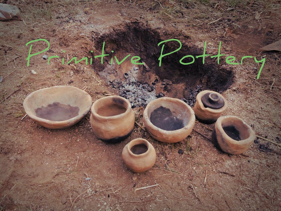 Primitive pottery firing pit with finished vessels