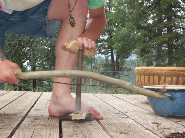 Bow drill fire making technique in action
