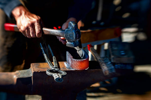 Blacksmith hammering heated metal on an anvil